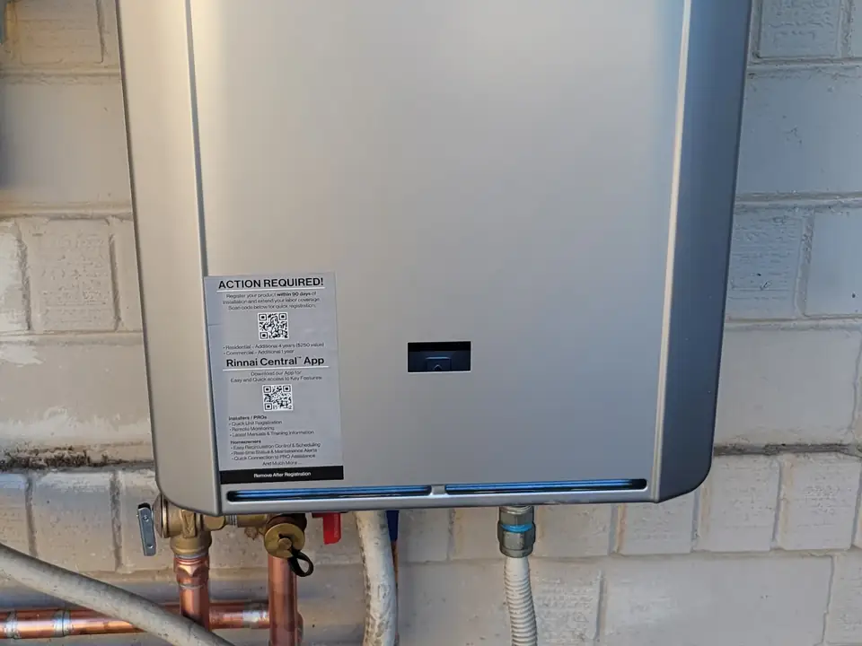 Tankless water heater mounted on an exterior wall